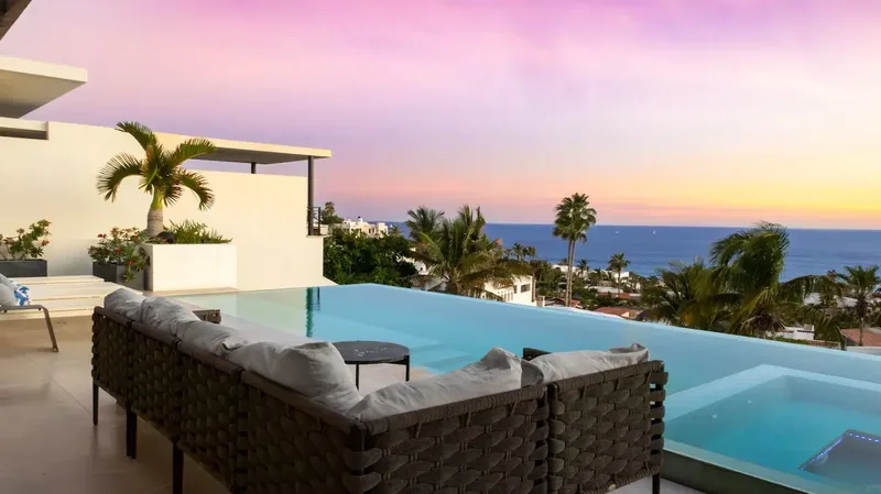 Casa Texas infinity pool and hot tub at sunset overlooking the ocean