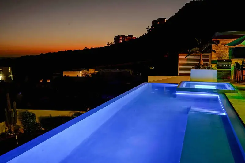 Casa Texas hot tub glowing at night on the pool terrace