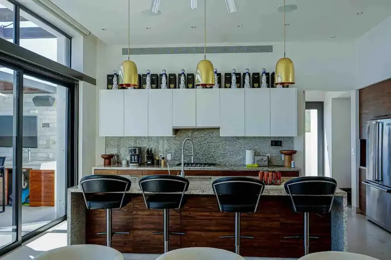 Casa Texas kitchen island with gold pendants