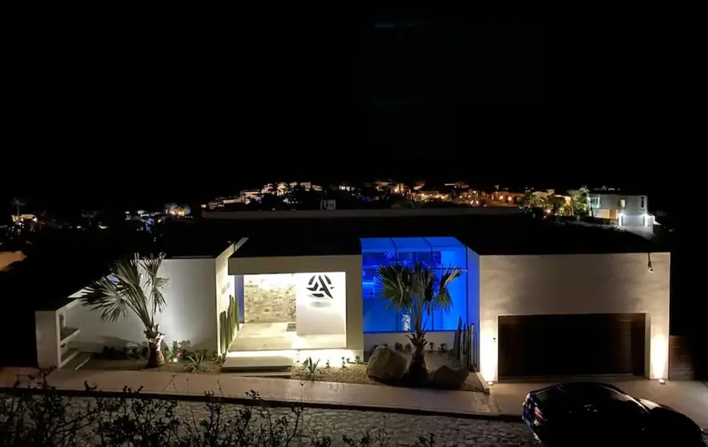 Casa Texas villa glowing at night on the Pedregal hillside